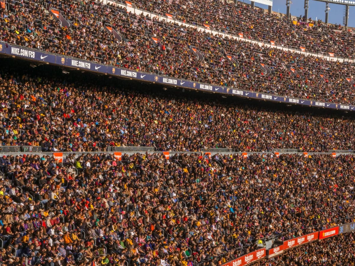 A packed stadium crowd filling the tiers, seen from across the bowl